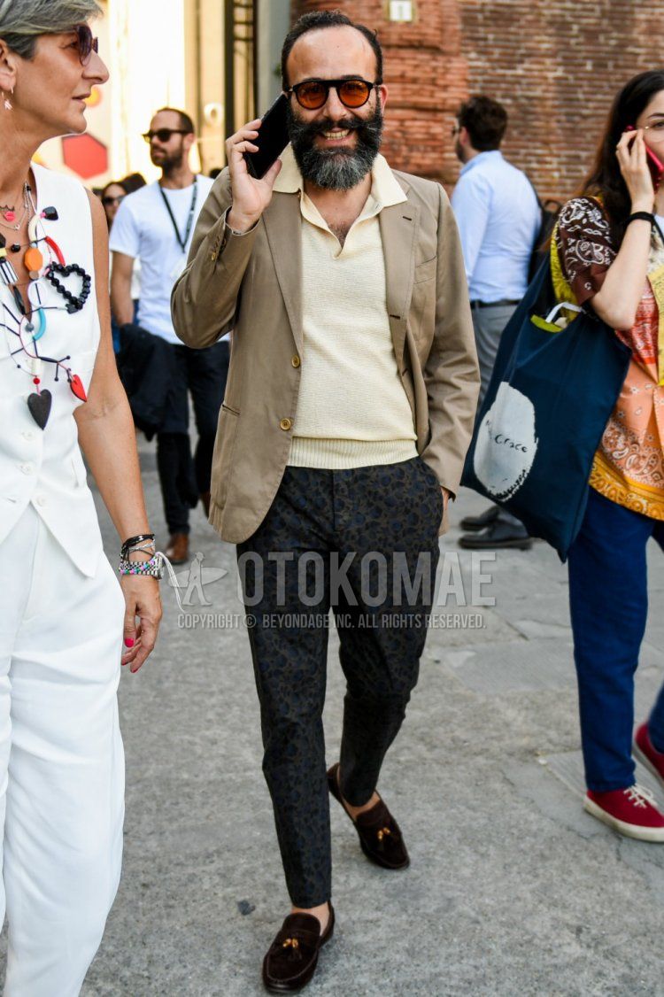 Men's spring, summer, and fall coordinate and outfit with plain black sunglasses, plain beige tailored jacket, plain beige polo shirt, dark gray leopard slacks, and suede brown coin loafer leather shoes.