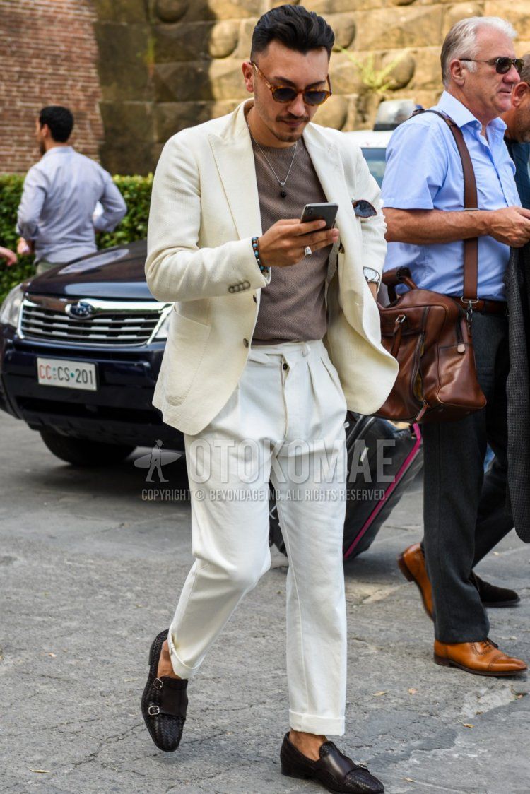 Men's spring, summer, and fall coordinate and outfit with brown tortoiseshell sunglasses, plain white tailored jacket, plain brown t-shirt, plain white beltless pants, and brown monk shoe leather shoes.