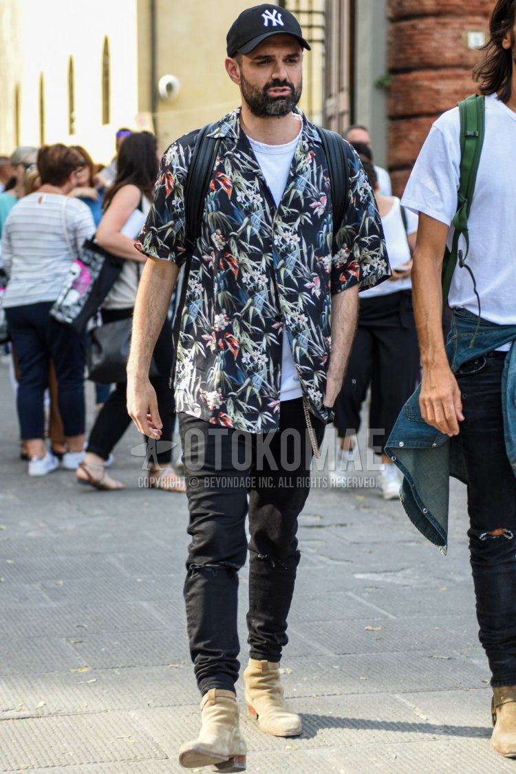 Men's spring/summer/fall coordination and outfit with black one-pointed baseball cap, open collar black botanical shirt, plain black damaged jeans, and beige boots.