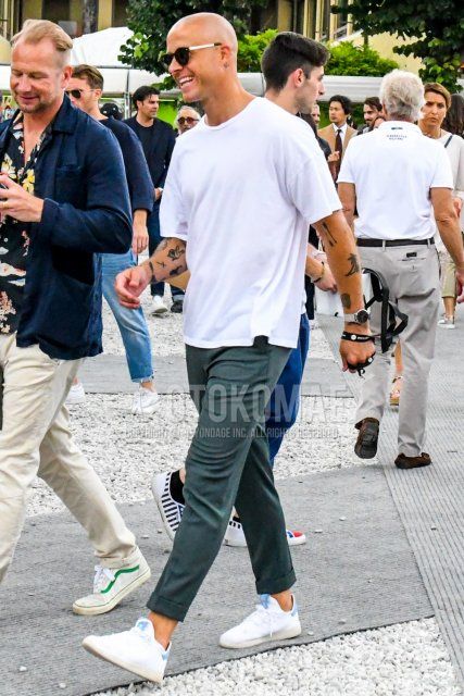 Men's spring and summer coordinate and outfit with plain black sunglasses, plain white t-shirt, plain gray slacks, and white low-cut sneakers.
