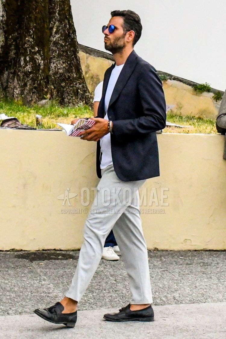 Men's spring, summer, and fall outfits and outfits with plain sunglasses, plain black tailored jacket, plain white t-shirt, plain white slacks, plain white ankle pants, and black tassel loafer leather shoes.