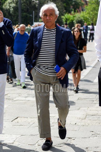 Men's spring, summer, and fall coordination and outfit with plain navy tailored jacket, white/black striped t-shirt, plain gray slacks, and suede black bit loafer leather shoes.