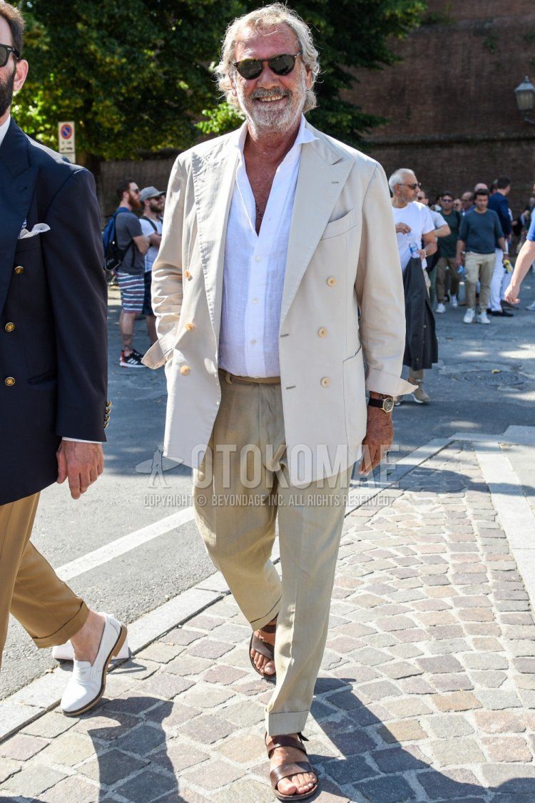 Men's spring, summer, and fall outfits with plain black sunglasses, plain beige tailored jacket, plain white linen shirt, plain beige slacks, and leather sandals.