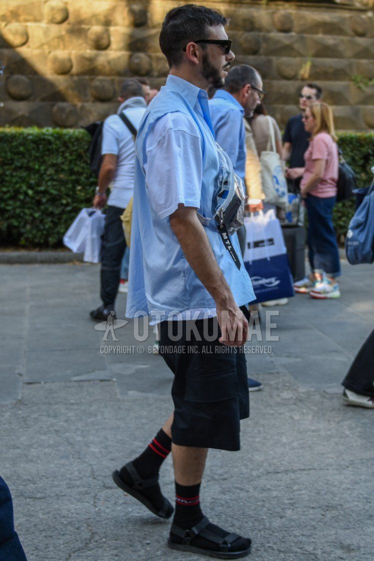 Men's summer coordinate and outfit with plain black sunglasses, plain light blue shirt, plain white t-shirt, plain black shorts, plain cargo pants, black socks socks, and black sports sandals.