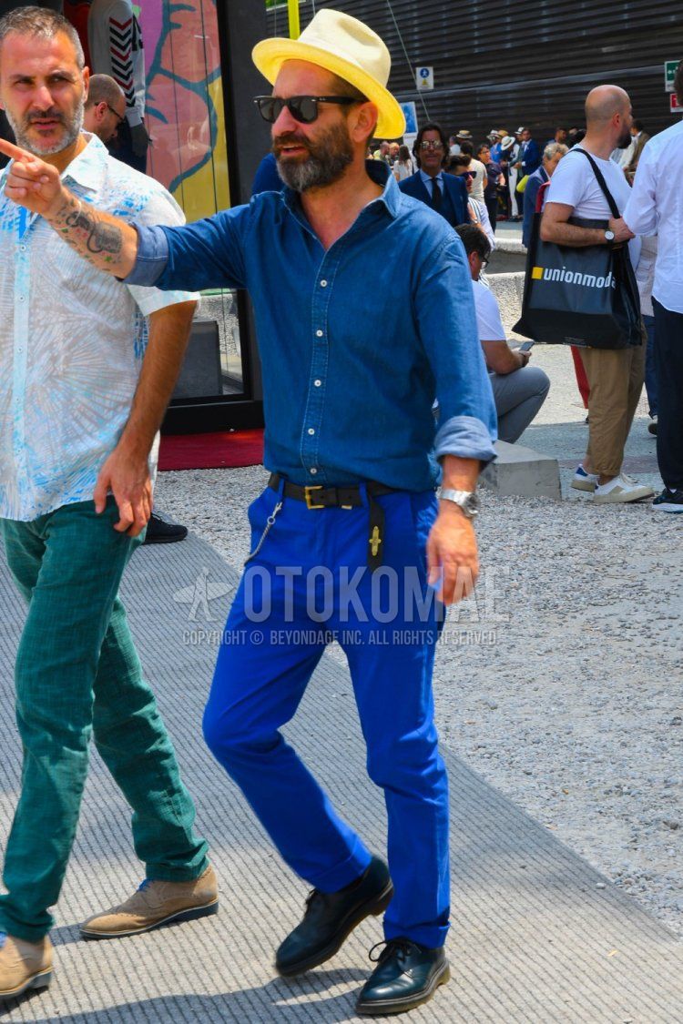 Men's spring/summer outfit with solid hat, solid sunglasses, solid blue denim/chambray shirt, solid black leather belt, solid blue cotton pants, and black plain toe leather shoes.