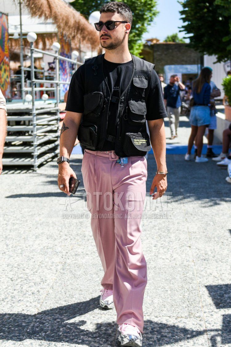 Summer men's coordinate and outfit with plain black sunglasses, plain black casual vest, black one-pointed t-shirt from Acoldwall, plain pink slacks, plain pleated pants, and Raf Simons Adidas Oswego silver/pink low-cut sneakers.