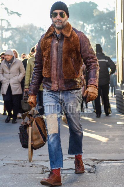 Men's fall/winter coordinate and outfit with solid black knit cap, solid silver sunglasses with teardrops, solid brown leather jacket (not riders), solid blue damaged jeans, solid red socks, solid brown plain toe leather shoes, solid beige backpack. .