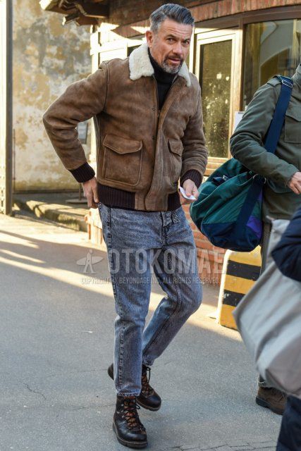 Men's fall/winter outfit/coordination with solid beige leather jacket (not riders), solid black turtleneck knit, solid gray denim/jeans, solid gray cropped pants, and brown boots.