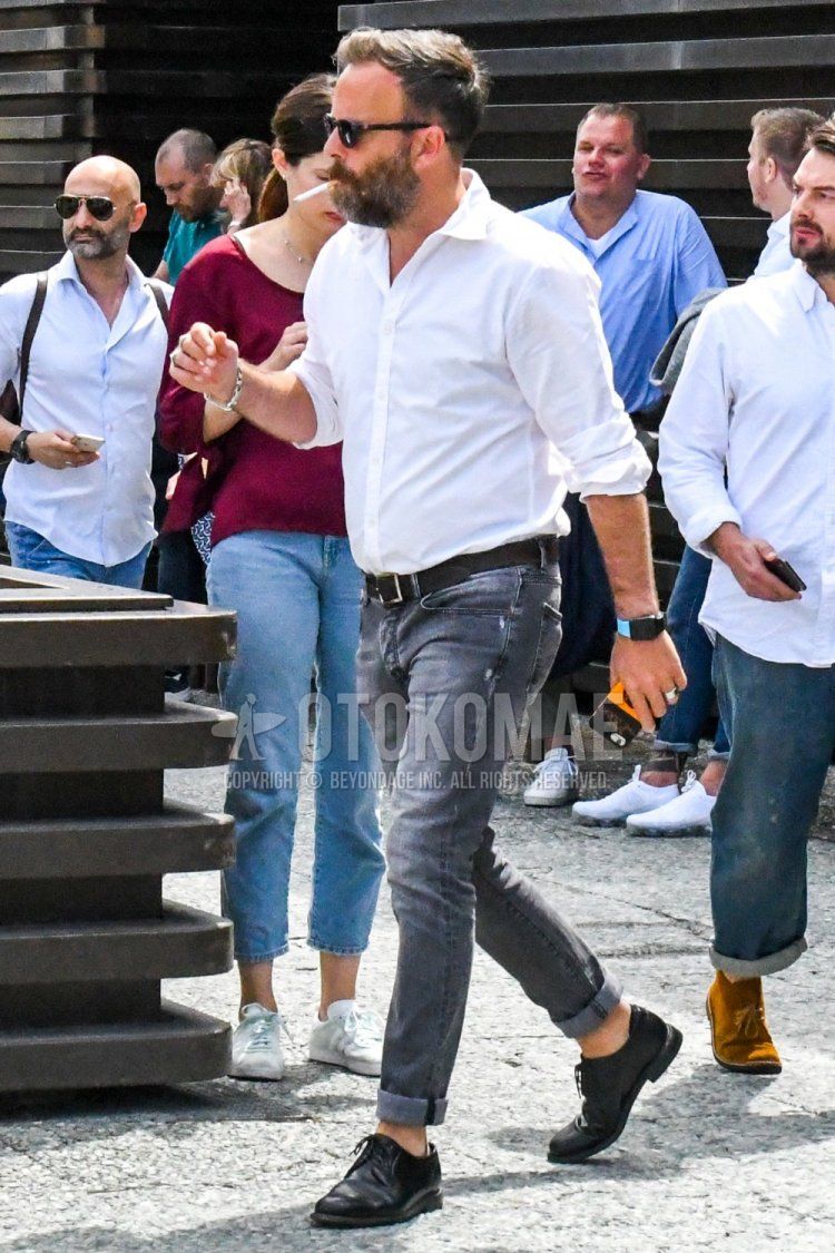Summer men's coordinate and outfit with plain white shirt, plain black leather belt, plain gray denim/jeans, and black plain toe leather shoes.