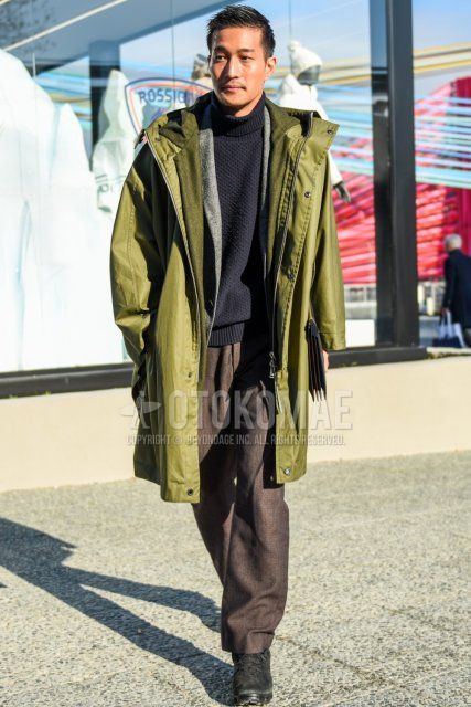 Men's fall/winter coordinate and outfit with olive green solid color hooded coat, gray solid color tailored jacket, dark gray solid color turtleneck knit, brown solid color slacks, and black low-cut sneakers.