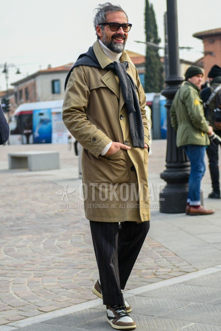 Men's fall/winter coordinate and outfit with plain black sunglasses, plain beige trench coat, plain white turtleneck knit, plain gray sweater, gray striped slacks, Nike Air Jordan 1 Travis Scott white and brown high-cut sneakers.