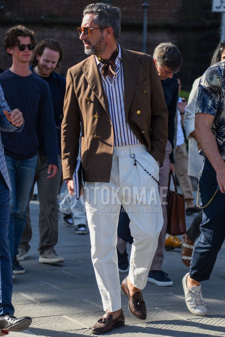 Men's spring/summer/fall outfit with brown tortoiseshell sunglasses, brown stole bandana/neckerchief, plain beige tailored jacket, white/brown striped shirt, plain white beltless pants, brown tassel loafer leather shoes.