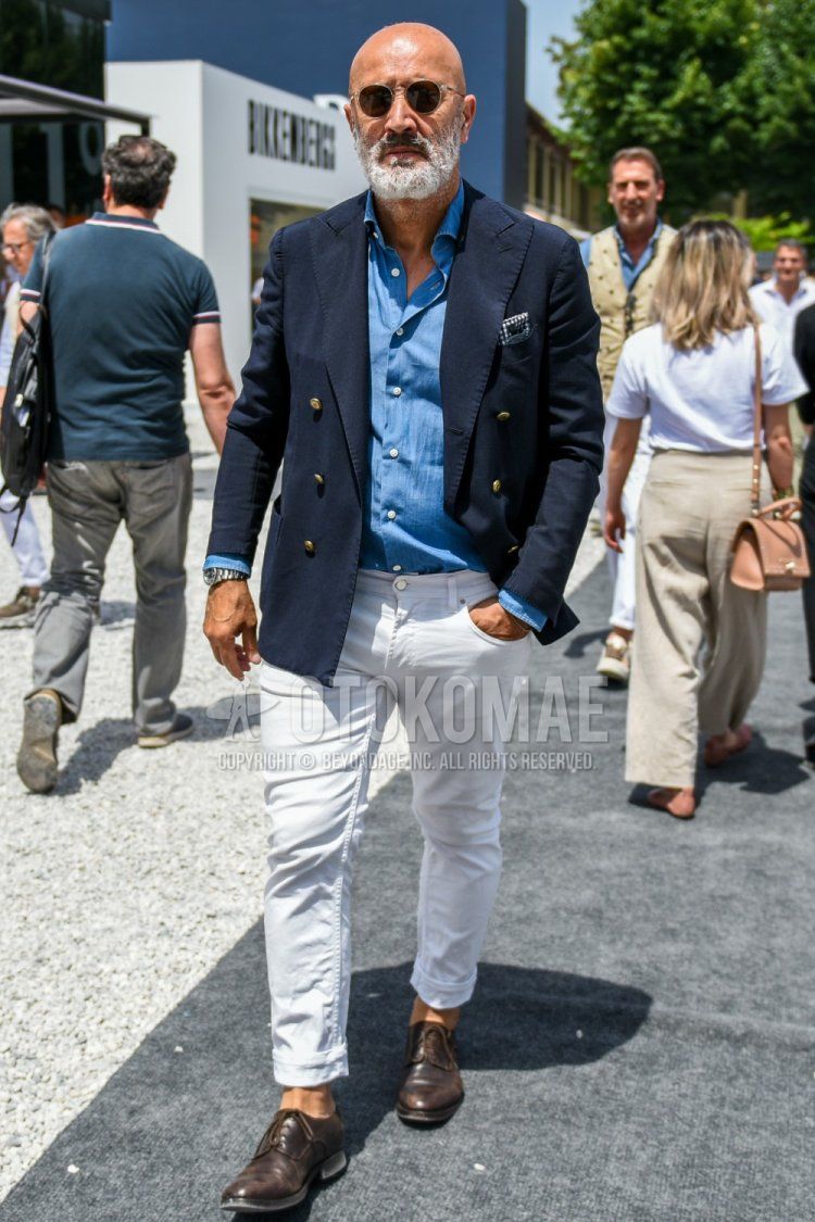 Men's spring/autumn coordinate and outfit with plain silver sunglasses, plain navy tailored jacket, plain blue denim/chambray shirt, plain white denim/jeans, and brown plain toe leather shoes.