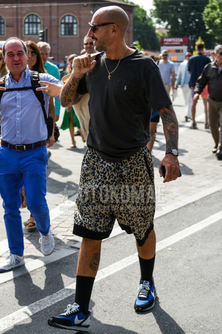 Men's summer coordinate and outfit with plain sunglasses, Polo Ralph Lauren plain black t-shirt, beige/black leopard shorts, plain black socks, and Nike Undercover Daybreak black and blue low-cut sneakers.
