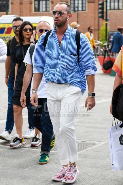 Men's spring/summer coordinate and outfit with clear plain sunglasses, light blue striped shirt, plain white cotton pants, plain pleated pants, and Nike pink low-cut sneakers.
