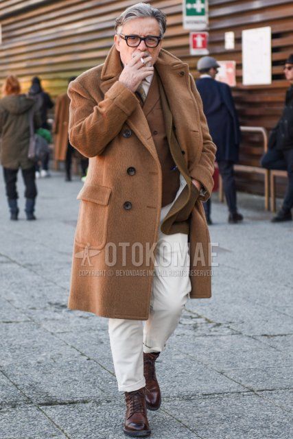 Men's fall/winter coordinate and outfit with plain black Tom Ford glasses, plain beige Ulster coat, plain brown gilet, plain beige tailored jacket, plain white cotton pants, and brown work boots.