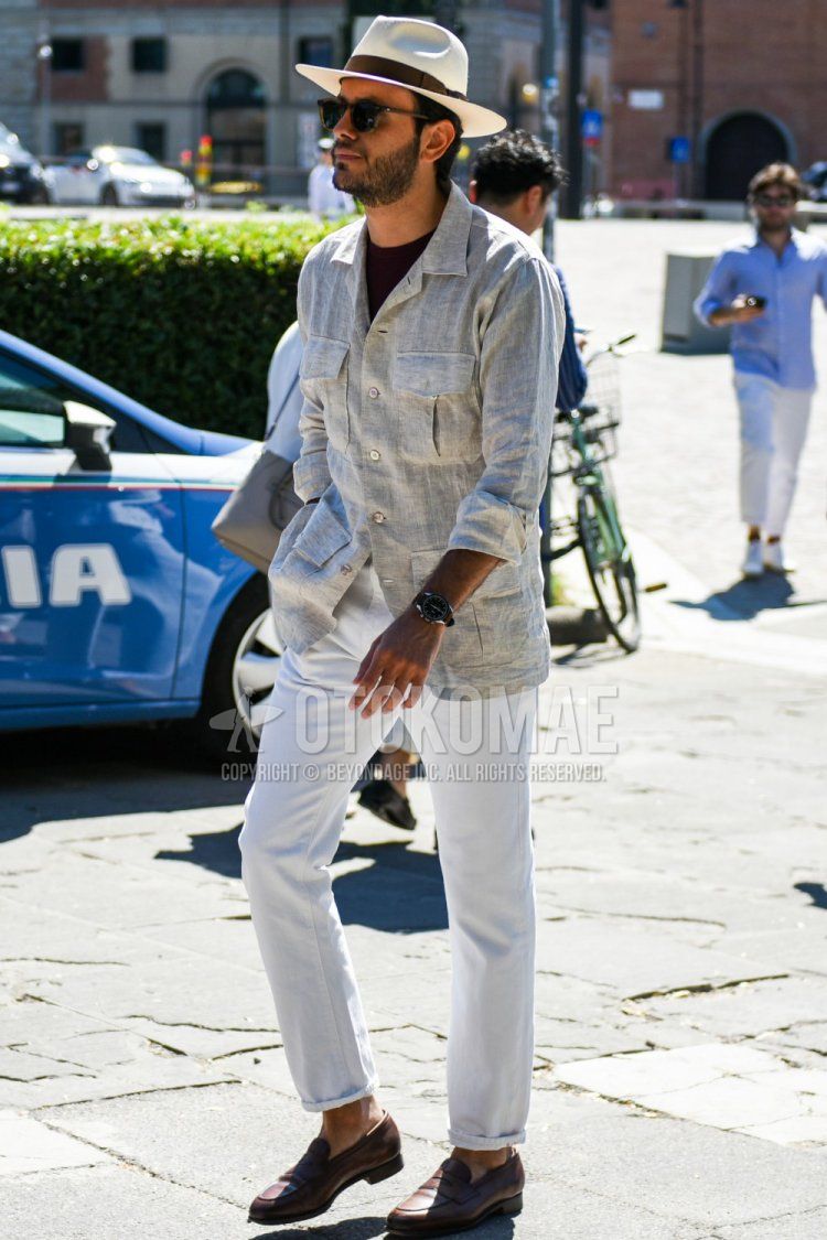 Men's spring and summer coordinate and outfit with solid beige hat, solid brown sunglasses, solid beige linen shirt, solid black linen t-shirt, solid beige chinos, and brown coin loafer leather shoes.