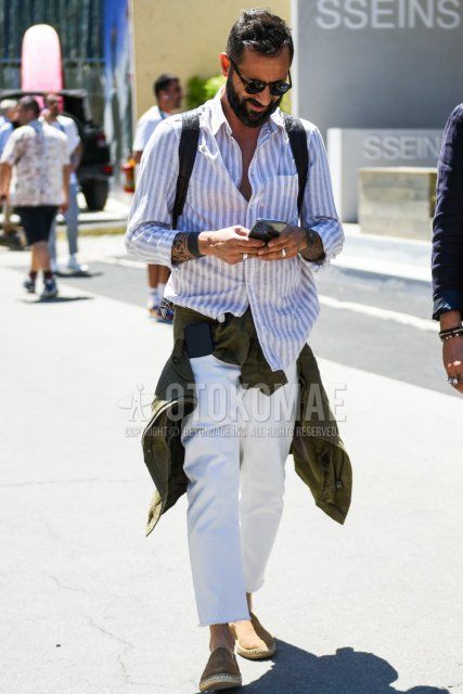 Men's spring/summer coordinate and outfit with beige tortoiseshell sunglasses, white/beige striped shirt, plain white cotton pants, and plain beige espadrilles.