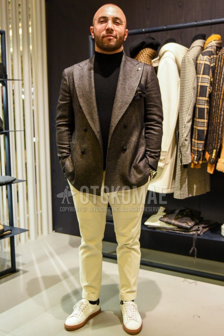 Men's spring and fall coordinate and outfit with gold solid glasses, brown solid tailored jacket, black solid turtleneck knit, beige solid winter pants (corduroy,velour), navy solid socks, and white low-cut sneakers.