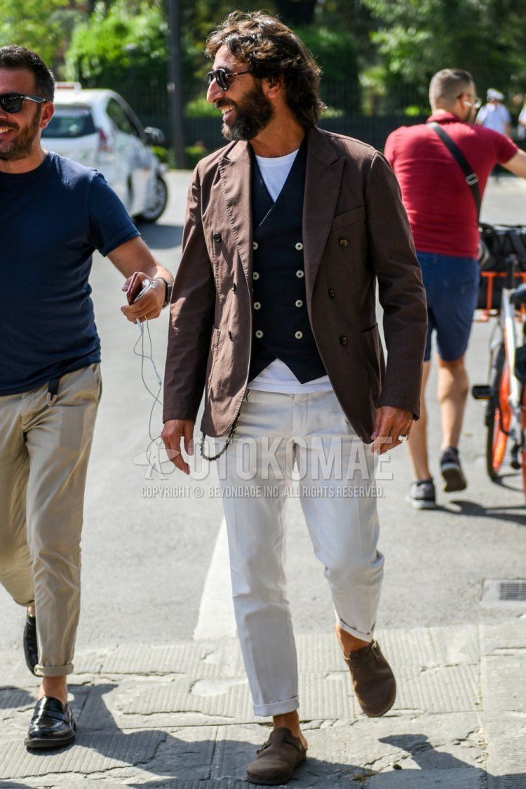 Men's spring and fall coordinate and outfit with plain black sunglasses, plain brown tailored jacket, plain black gilet, plain white t-shirt, plain white cotton pants, and brown suede shoes leather shoes.