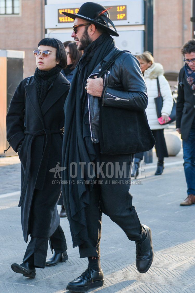 Solid black hat, brown tortoiseshell sunglasses, solid dark gray scarf/stall, solid black rider's jacket, solid dark gray cotton pants, solid dark gray socks, solid black plain toe leather shoes, solid black briefcase/handbag for fall/winter Men's Codes and Outfits.