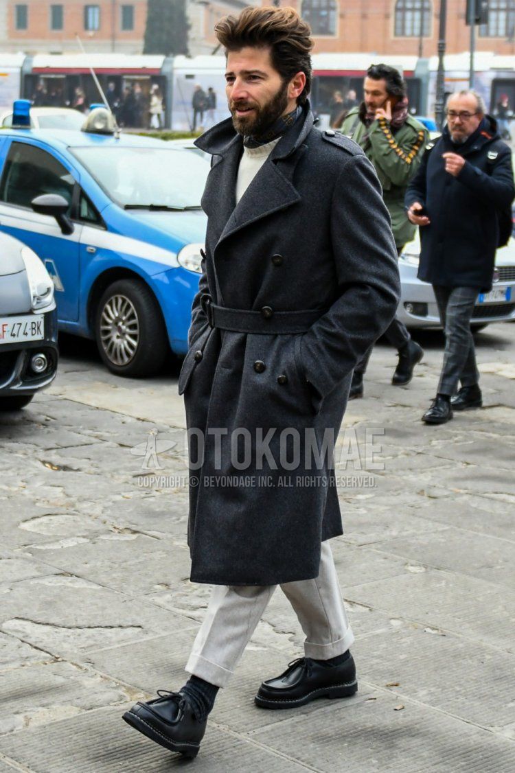 Winter men's outfit and outfit with dark gray solid color belted coat, white solid color sweater, white solid color slacks, black solid color socks, and black leather shoes.