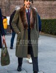 Men's fall/winter outfit with plain black sunglasses from Boston, plain olive green chester coat, light blue striped shirt, dark gray plain socks, black coin loafer leather shoes, gray striped suit, navy tie.