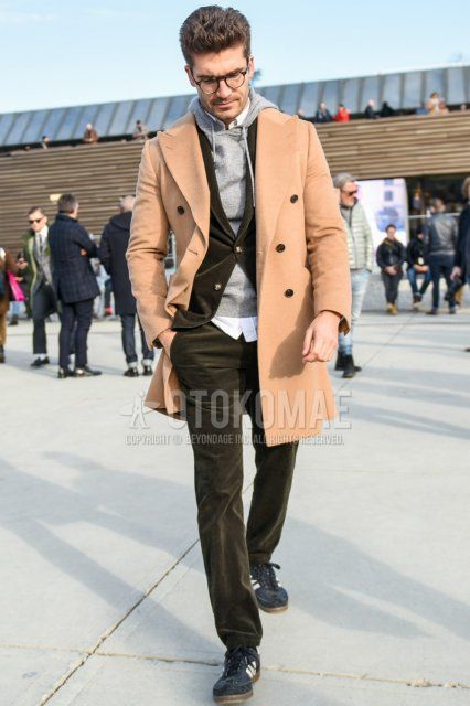Men's fall/winter coordinate and outfit with brown tortoiseshell glasses, plain beige chester coat, knit plain gray hoodie, plain white shirt, Adidas navy low-cut sneakers, and plain olive green suit.