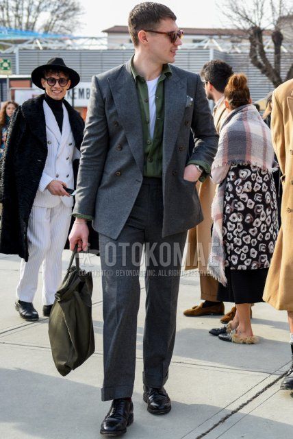 Men's fall/winter outfit with brown tortoiseshell sunglasses from Boston, olive green solid color shirt, gray solid color slacks, gray solid color beltless pants, black straight tip leather shoes, olive green solid color briefcase/handbag, gray solid color suit.