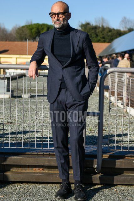 Men's spring and fall coordination and outfit with Boston plain black glasses, plain navy turtleneck knit, plain black socks, black wingtip leather shoes, and navy striped suit.