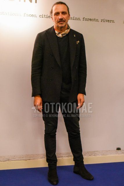 Men's spring, summer, and fall coordination and outfit with beige stole bandana/neckerchief, plain black t-shirt, suede black side gore boots, and plain black suit.