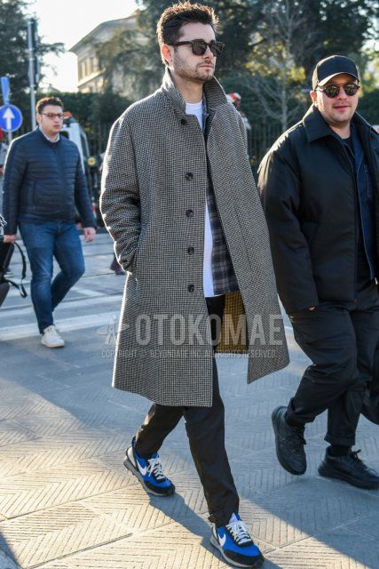 Men's fall/winter outfit with plain black Wellington sunglasses, gray checked stainless steel coat, plain white t-shirt, gray/black checked shirt, plain black cotton pants, Nike Undercover Daybreak blue/black low-cut sneakers.