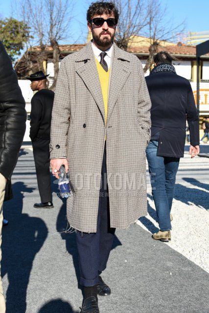 Men's fall/winter outfit and outfit with plain black sunglasses, beige check chester coat, plain yellow sweater, plain white shirt, plain gray slacks, plain gray cropped pants, plain black socks, black leather shoes, and black dot tie.