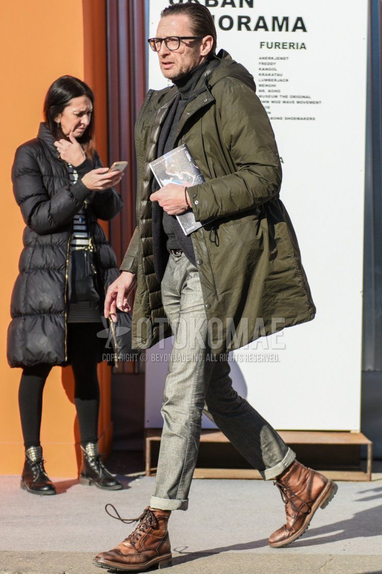Men's fall/winter coordinate/outfit with plain black glasses, plain olive green hooded coat, plain olive green down jacket, plain gray turtleneck knit, plain gray tailored jacket, plain gray denim/jeans, and brown boots.