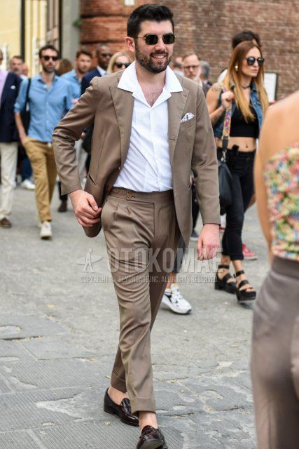 Men's spring, summer, and fall coordination and outfit with square gold and black plain sunglasses, open-collar plain white shirt, and plain brown suit.