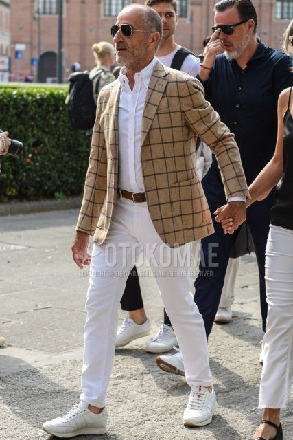 Men's spring, summer, and fall outfit with plain gold sunglasses, beige checked tailored jacket, plain white shirt, plain brown leather belt, plain white cotton pants, and white low-cut sneakers.