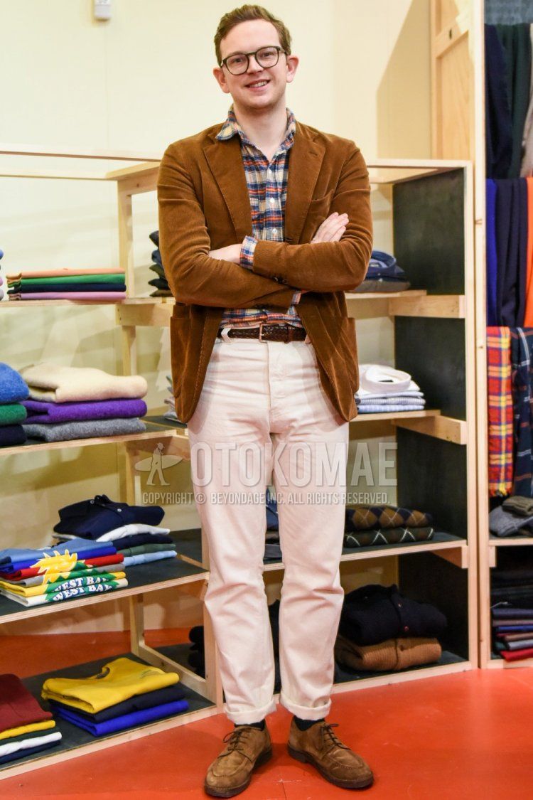 Men's fall/winter outfit with plain black glasses, plain brown tailored jacket, multi-colored checked shirt, plain brown leather belt, plain white cotton pants, plain black socks, and suede beige U-tip leather shoes.