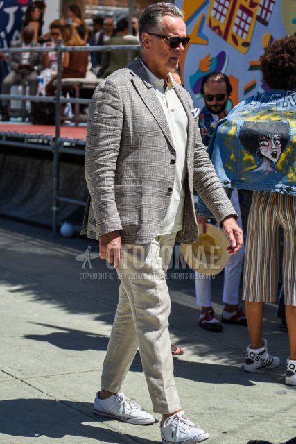 Men's spring and summer coordinate and outfit with beige tortoiseshell sunglasses, glen check gray check tailored jacket, plain white polo shirt, plain gray slacks, and white low-cut sneakers.