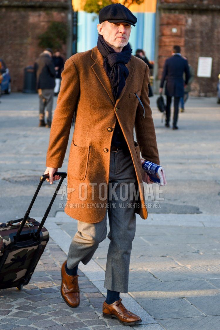 Men's fall/winter outfit with plain black hunting cap, plain black scarf/stall, plain brown chester coat, plain gray slacks, plain gray cropped pants, plain navy socks, and brown wingtip leather shoes.