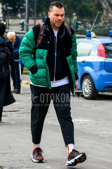 Winter men's coordinate and outfit with plain green down jacket, plain black MA-1, plain white t-shirt, dark gray ankle pants, white striped socks, and Nike multi-colored low-cut sneakers.