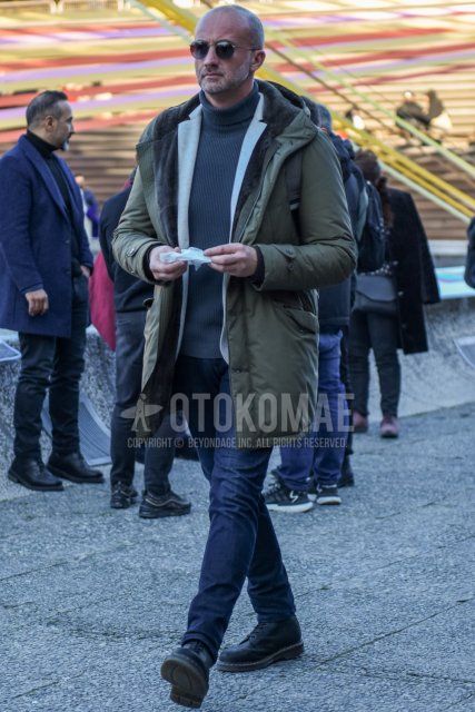 Winter men's coordinate and outfit with round plain silver sunglasses, plain olive green hooded coat, plain olive green down jacket, plain white tailored jacket, plain gray turtleneck knit, plain navy denim/jeans, and black boots.
