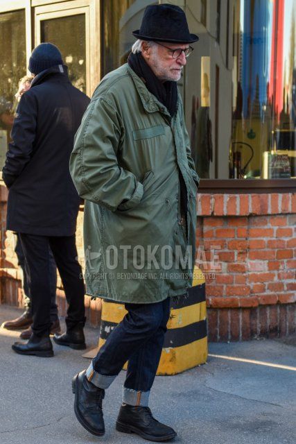 Men's fall/winter coordinate and outfit with plain black hat, plain black glasses, plain black scarf/stall, plain olive green mod coat, plain navy denim/jeans, and black wingtip leather shoes.