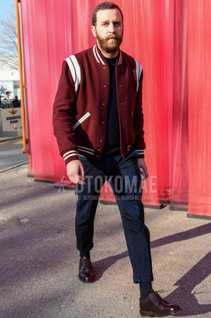 Men's fall/winter coordinate and outfit with red solid color stadium jacket, black solid color sweatshirt, navy solid color denim/jeans, black solid color socks, and black plain toe leather shoes.