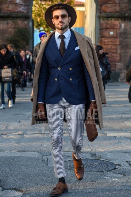 Solid beige hat, solid silver sunglasses, solid beige chester coat, solid navy tailored jacket, solid white shirt, white/blue striped slacks, white/blue striped cropped pants, solid gray socks, brown monk shoe leather shoes, Men's fall/winter outfit with plain brown clutch/second bag/drawstring, plain brown tie.