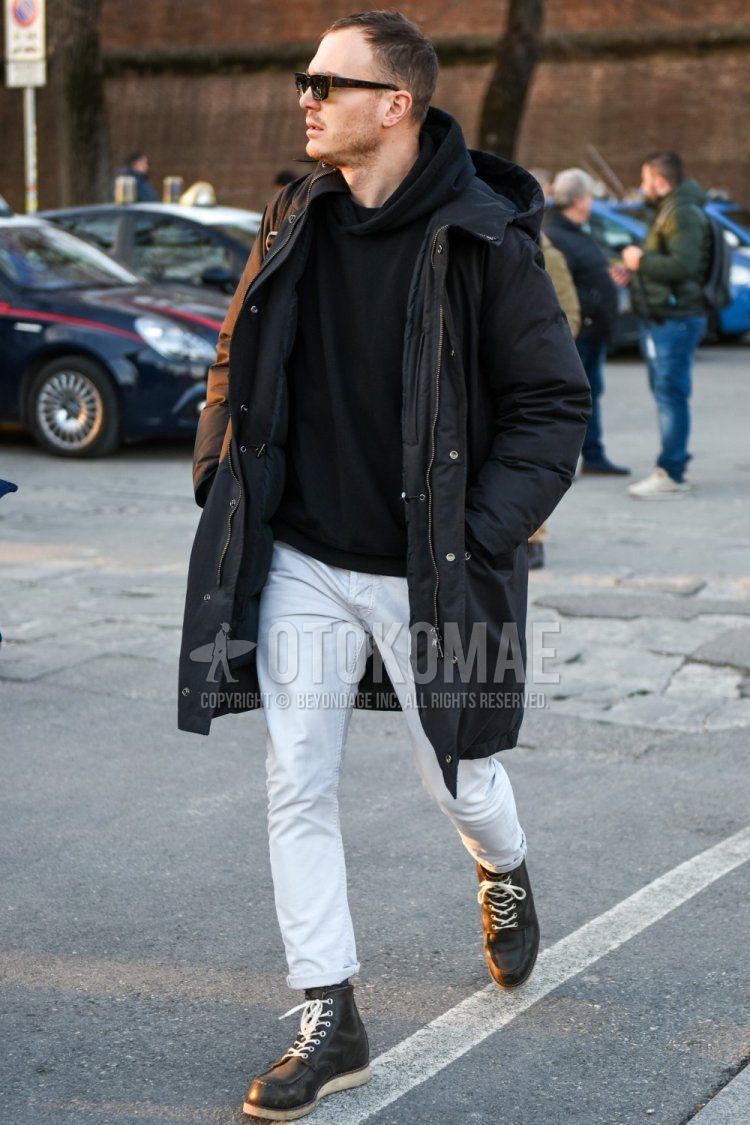 Men's fall/winter coordinate and outfit with brown tortoiseshell sunglasses, plain black hooded coat, plain black hoodie, plain white cotton pants, and black work boots.