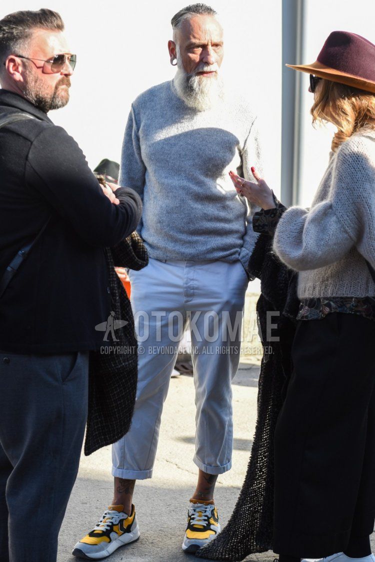 Men's spring and fall coordinate and outfit with plain gray turtleneck knit, plain white cotton pants, and yellow-cut sneakers.