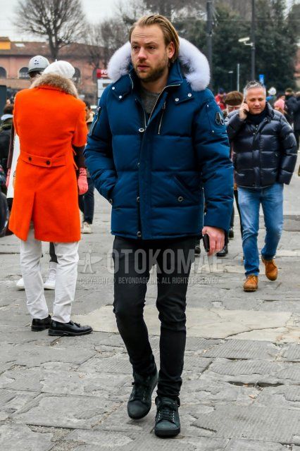 Winter men's coordinate and outfit with plain navy down jacket, plain black cotton pants, and dark gray low-cut sneakers.