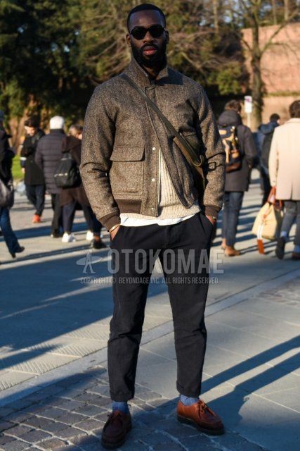 Men's fall/winter outfit and outfit with plain black sunglasses, plain brown coveralls, plain beige sweater, plain white t-shirt, plain black chinos, plain gray socks, and brown leather shoes.