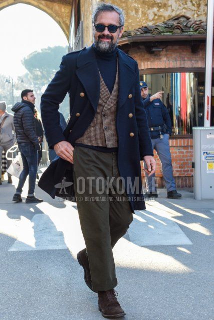 Men's fall/winter outfit with Boston plain black sunglasses, plain navy trench coat, plain navy turtleneck knit, brown check gilet, plain brown chinos, and suede brown boots.
