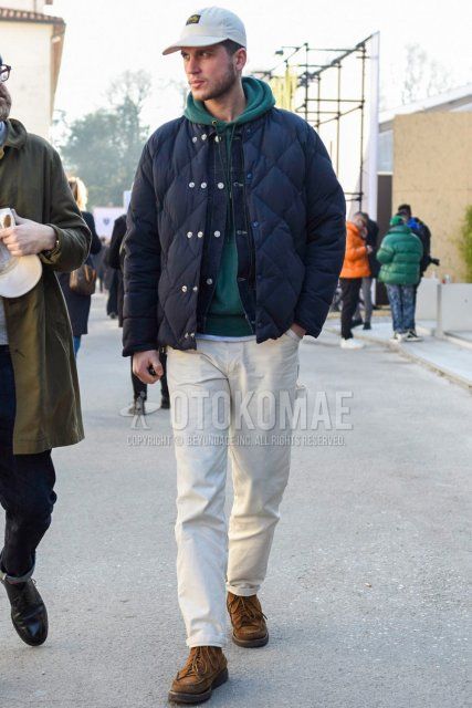 Men's fall/winter coordinate and outfit with one-pointed white baseball cap, plain navy down jacket, plain navy denim jacket, plain green hoodie, plain white cotton pants, and suede brown boots.